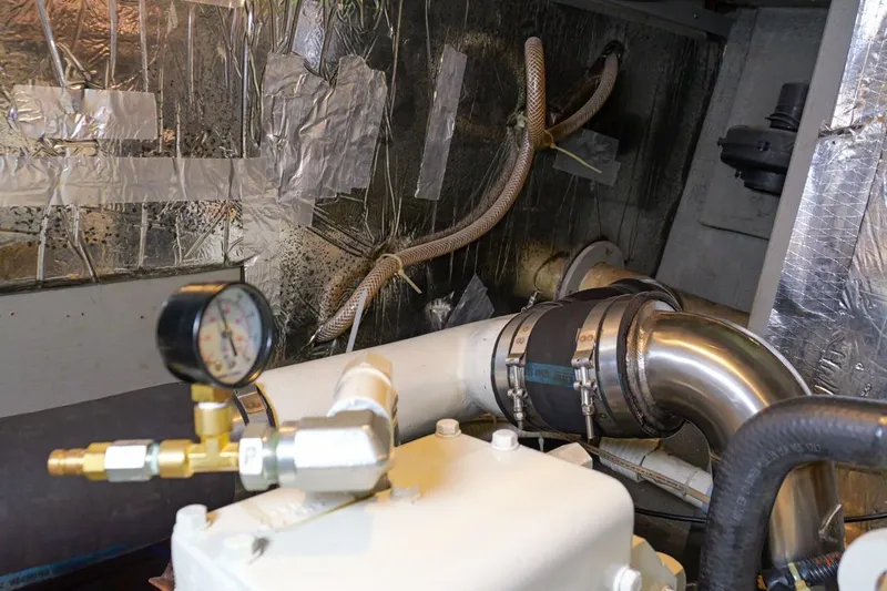 Rose Petal Yacht Photos Pics Engine room of 1981 Tollycraft 48 Cockpit Motor Yacht with pipes and pressure gauge.