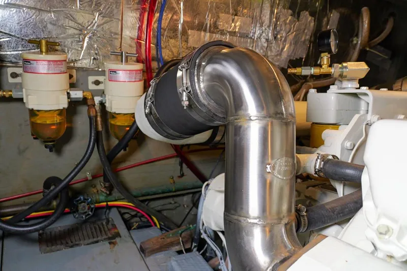 Rose Petal Yacht Photos Pics Engine room of 1981 Tollycraft 48 Cockpit Motor Yacht with fuel filters and exhaust pipe.