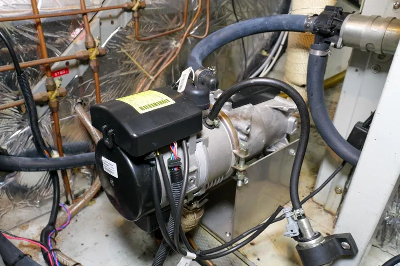 Rose Petal Yacht Photos Pics Engine compartment of 1981 Tollycraft 48 Cockpit Motor Yacht, featuring mechanical components and wiring.