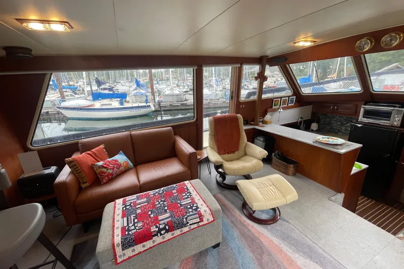 Rose Petal Yacht Photos Pics Interior of 1981 Tollycraft 48 Cockpit Motor Yacht with cozy seating and marina view.