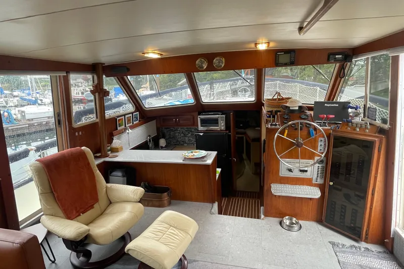 Rose Petal Yacht Photos Pics 1981 Tollycraft 48 Cockpit Motor Yacht interior with helm, seating, and marina view.
