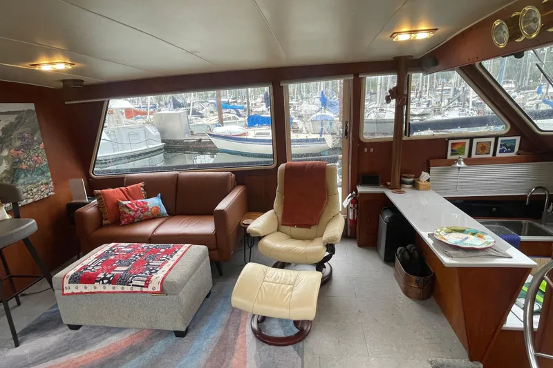Rose Petal Yacht Photos Pics Interior of 1981 Tollycraft 48 Cockpit Motor Yacht with cozy seating and marina view.