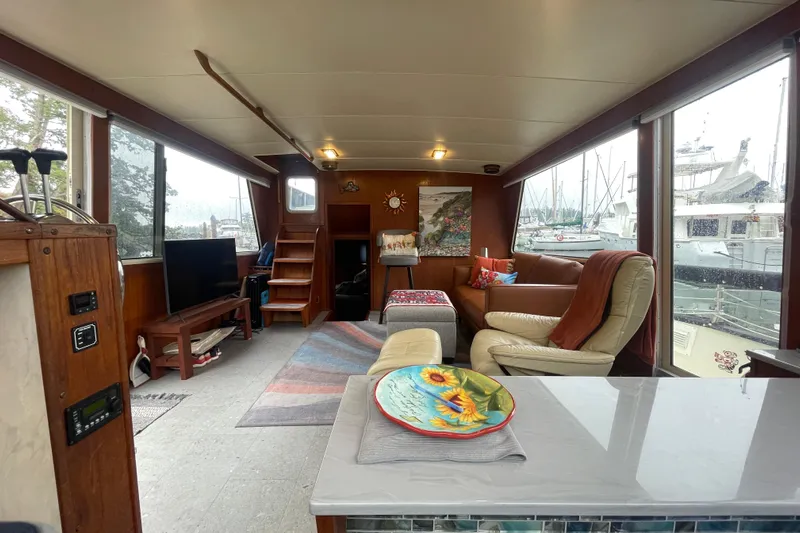 Rose Petal Yacht Photos Pics Interior of 1981 Tollycraft 48 Cockpit Motor Yacht with cozy seating and marina view.