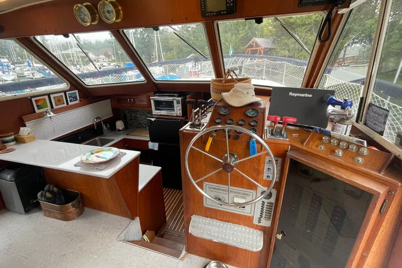 Rose Petal Yacht Photos Pics 1981 Tollycraft 48 Cockpit Motor Yacht interior with helm, kitchen, and navigation equipment.