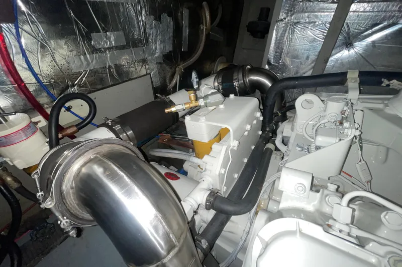 Rose Petal Yacht Photos Pics Engine room of 1981 Tollycraft 48 Cockpit Motor Yacht with visible components and piping.