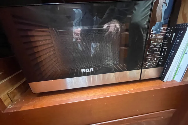 Rose Petal Yacht Photos Pics RCA microwave on wooden shelf inside 1981 Tollycraft 48 Cockpit Motor Yacht.