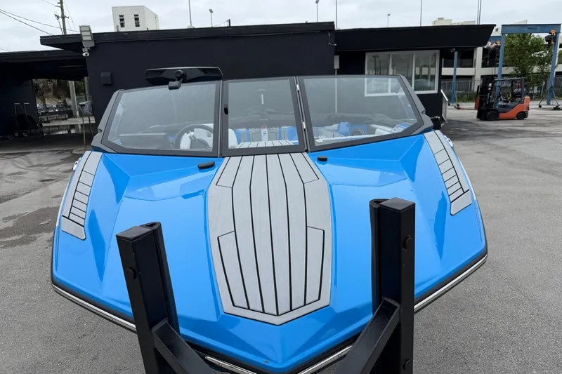  Yacht Photos Pics 2026 Nautique Ski Nautique boat in vibrant blue, parked outdoors.