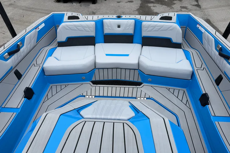  Yacht Photos Pics 2026 Nautique Ski Nautique boat interior with blue and gray seating and flooring.