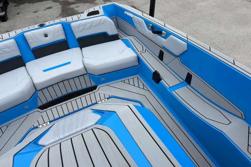  Yacht Photos Pics 2026 Nautique Ski Nautique boat interior with blue and gray seating and flooring.