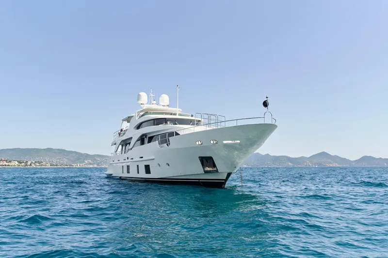 Sea Bear Yacht Photos Pics Luxury 2013 Benetti 93 Delfino yacht on open sea with scenic mountain backdrop.