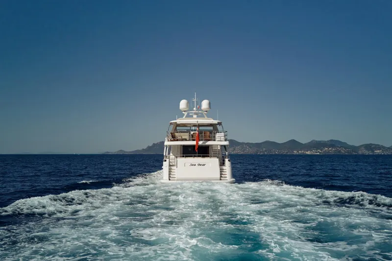 Sea Bear Yacht Photos Pics Luxury yacht Benetti 93 Delfino 2013 cruising on open sea with scenic coastline.