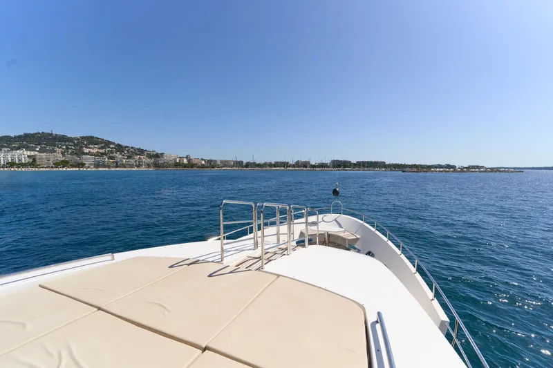 Sea Bear Yacht Photos Pics Bow view of 2013 Benetti 93 Delfino yacht cruising near coastal city.