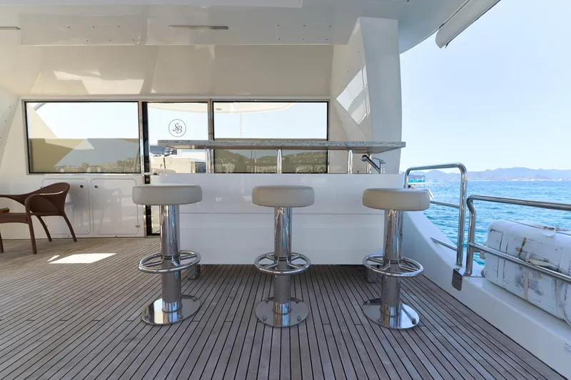 Sea Bear Yacht Photos Pics Luxurious Benetti 93 Delfino yacht deck with bar stools, ocean view, 2013 model.