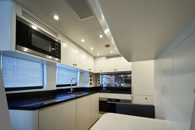 Sea Bear Yacht Photos Pics Modern kitchen interior on 2013 Benetti 93 Delfino yacht, featuring sleek cabinetry and appliances.