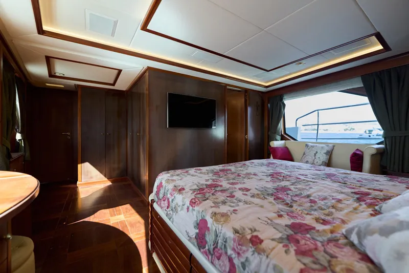 Sea Bear Yacht Photos Pics Luxurious bedroom interior on 2013 Benetti 93 Delfino yacht with floral bedding and elegant wood finishes.