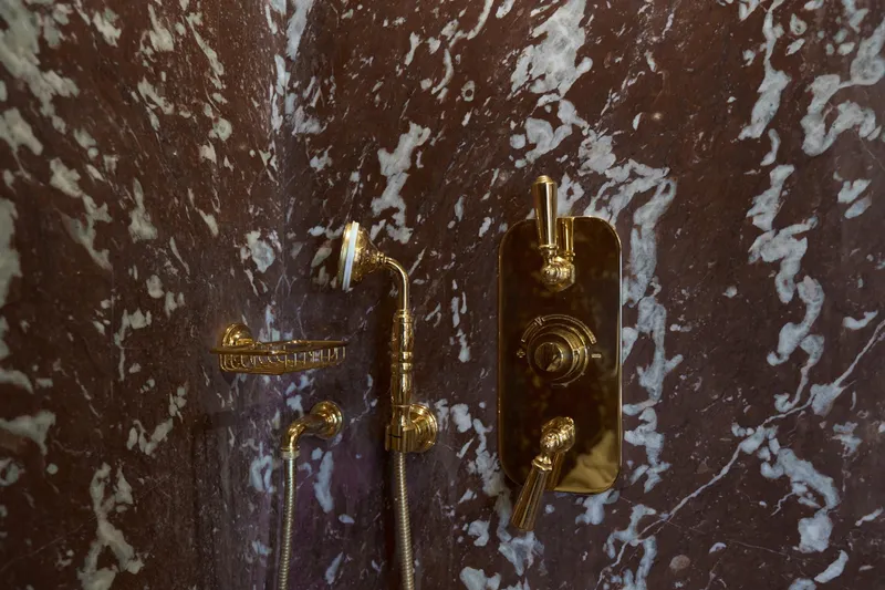 Sea Bear Yacht Photos Pics Luxurious gold shower fixtures on marbled wall, Benetti 93 Delfino yacht, 2013 model.