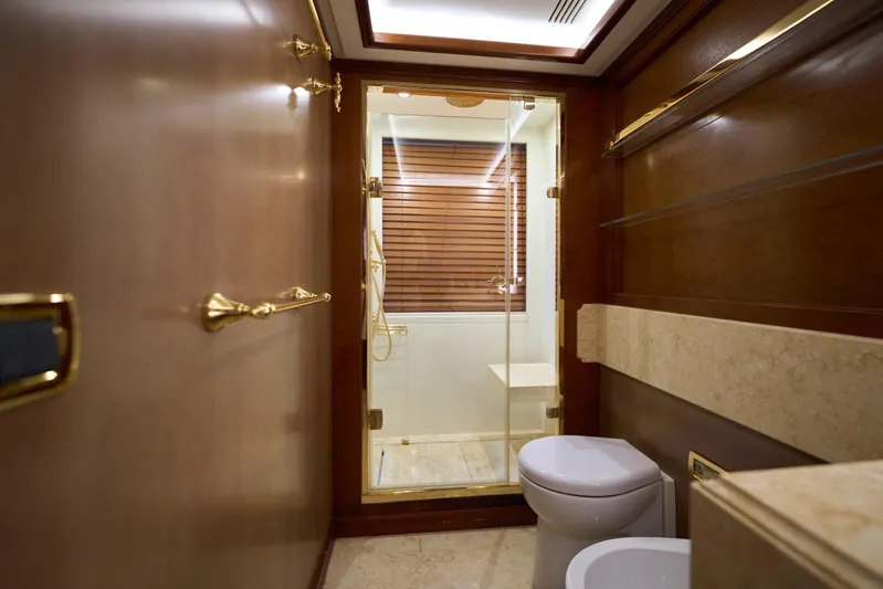 Sea Bear Yacht Photos Pics Luxurious bathroom on 2013 Benetti 93 Delfino yacht with elegant wood and gold accents.