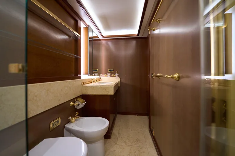 Sea Bear Yacht Photos Pics Luxurious bathroom on 2013 Benetti 93 Delfino yacht with elegant wood and gold accents.