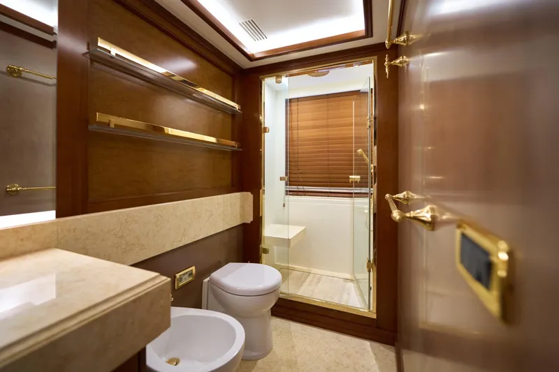 Sea Bear Yacht Photos Pics Luxurious bathroom on 2013 Benetti 93 Delfino yacht with elegant wood and gold accents.