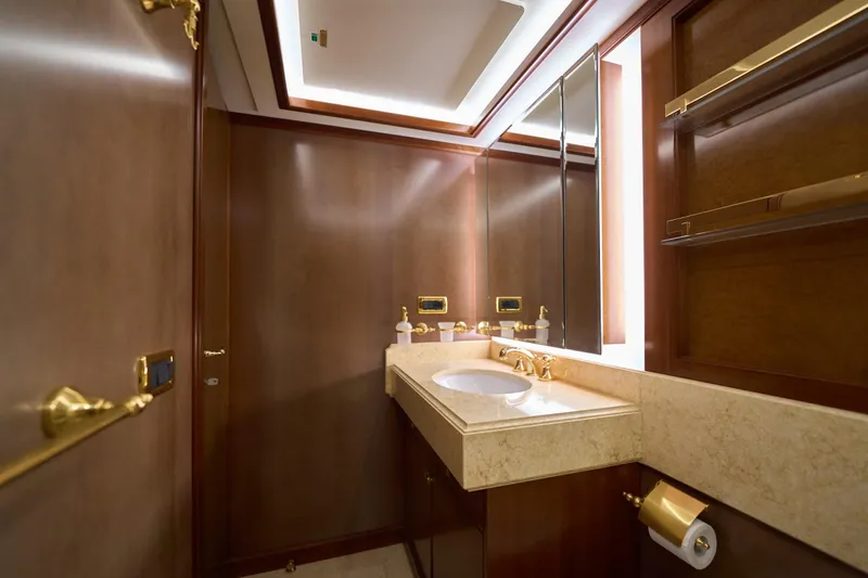Sea Bear Yacht Photos Pics Luxurious bathroom on 2013 Benetti 93 Delfino yacht with elegant wood and gold accents.