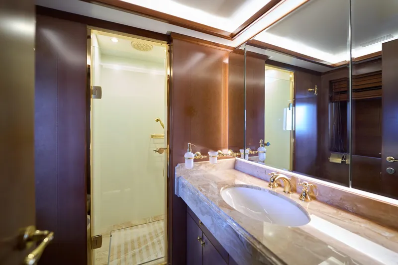 Sea Bear Yacht Photos Pics Luxurious bathroom on 2013 Benetti 93 Delfino yacht with marble countertop and gold fixtures.