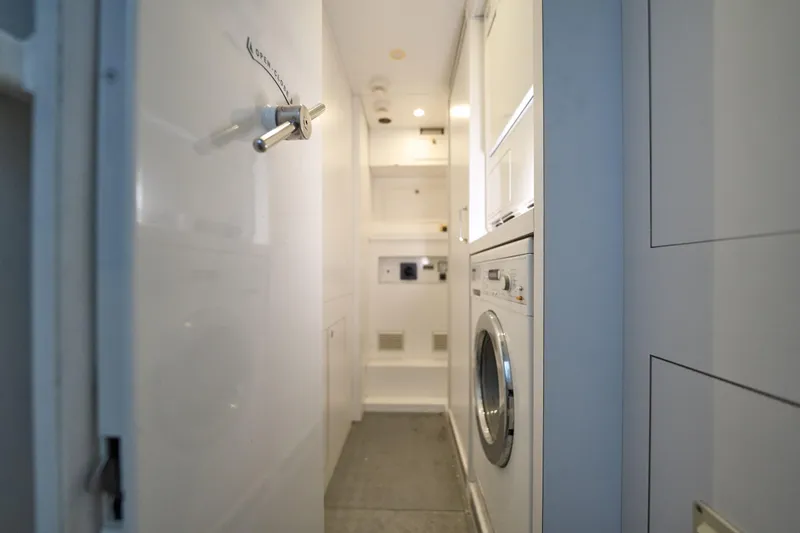 Sea Bear Yacht Photos Pics Laundry area inside 2013 Benetti 93 Delfino yacht, featuring modern appliances and sleek design.