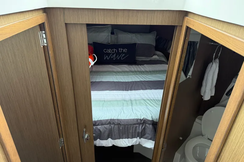  Yacht Photos Pics Cozy cabin interior of 2020 Jeanneau NC 895 with bed and bathroom.