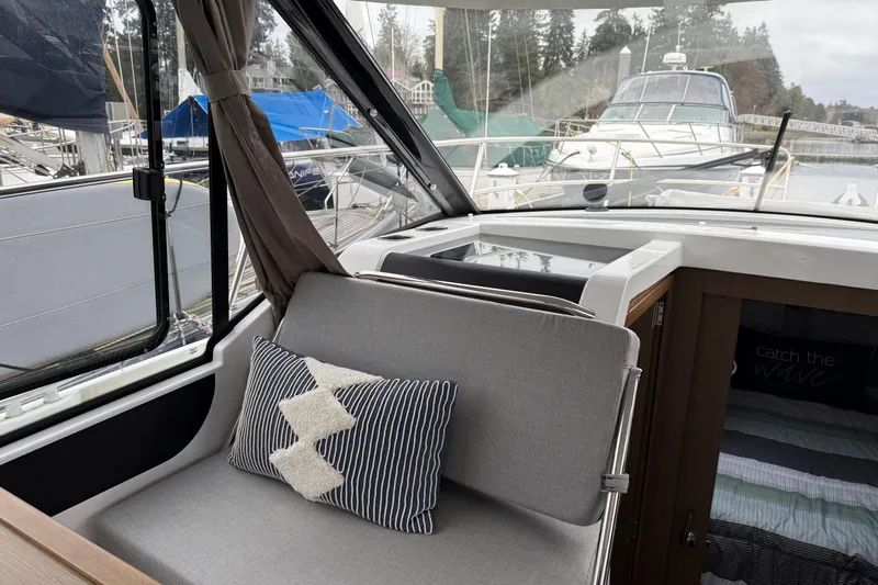  Yacht Photos Pics Interior of 2020 Jeanneau NC 895 boat with cozy seating and nautical decor.