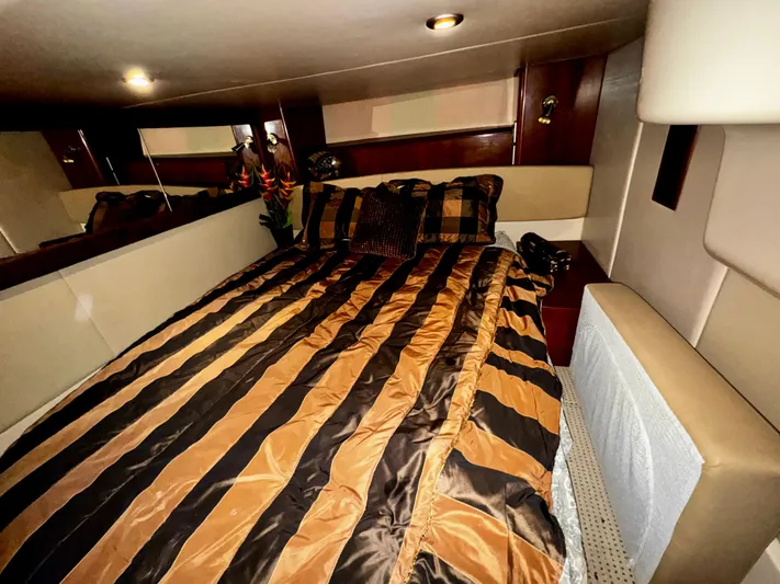  Yacht Photos Pics Luxurious bedroom interior of 2007 Meridian 411 Sedan yacht with striped bedding.
