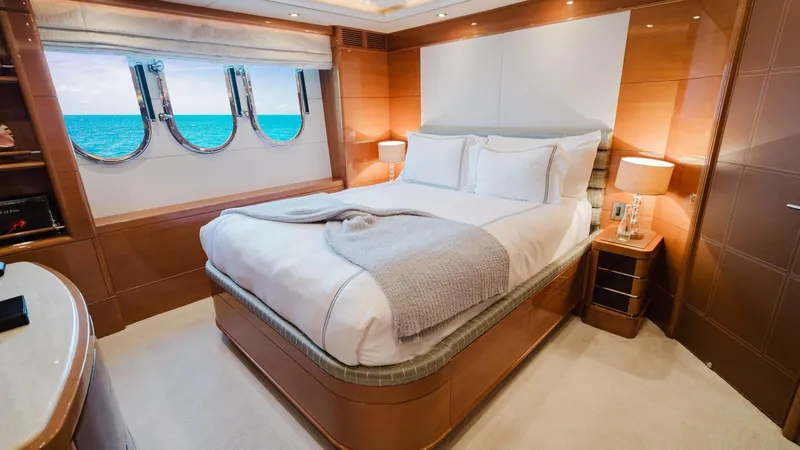 Groover Yacht Photos Pics Luxurious bedroom interior on 2009 Benetti 145 yacht with ocean view through portholes.