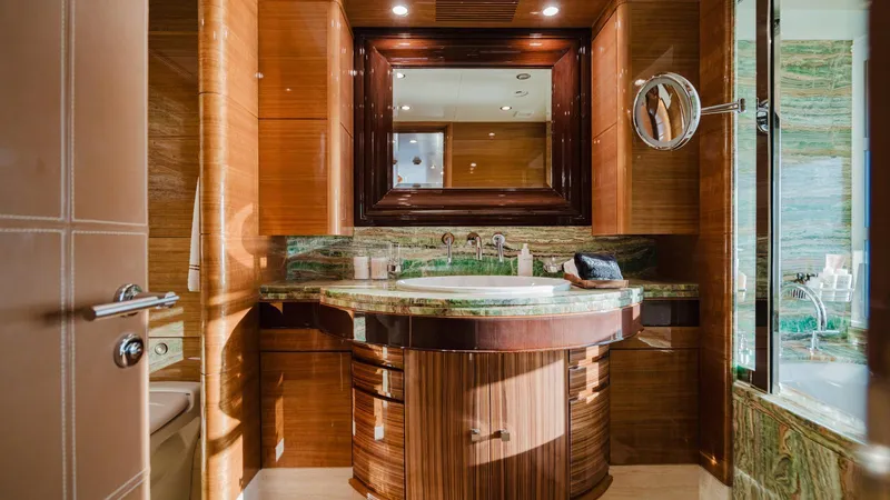 Groover Yacht Photos Pics Luxurious bathroom interior on 2009 Benetti 145 yacht, featuring elegant wood and marble finishes.