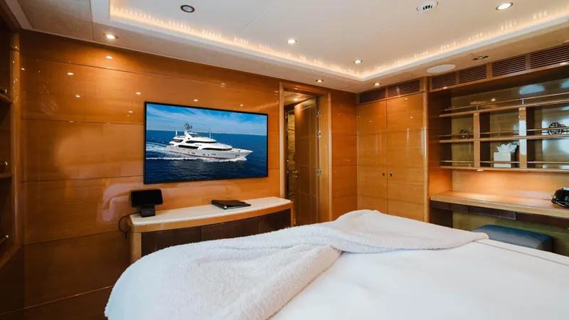 Groover Yacht Photos Pics Luxurious bedroom interior on 2009 Benetti 145 yacht with modern amenities and elegant wood paneling.