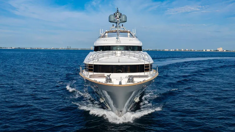 Groover Yacht Photos Pics Luxury yacht Benetti 145 (2009) cruising on open sea under clear blue sky.