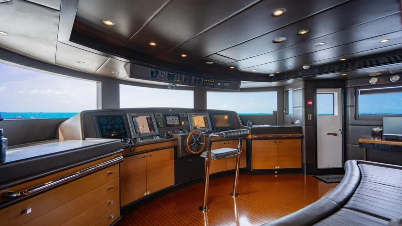 Groover Yacht Photos Pics Bridge of 2009 Benetti 145 yacht with modern navigation equipment and wooden accents.