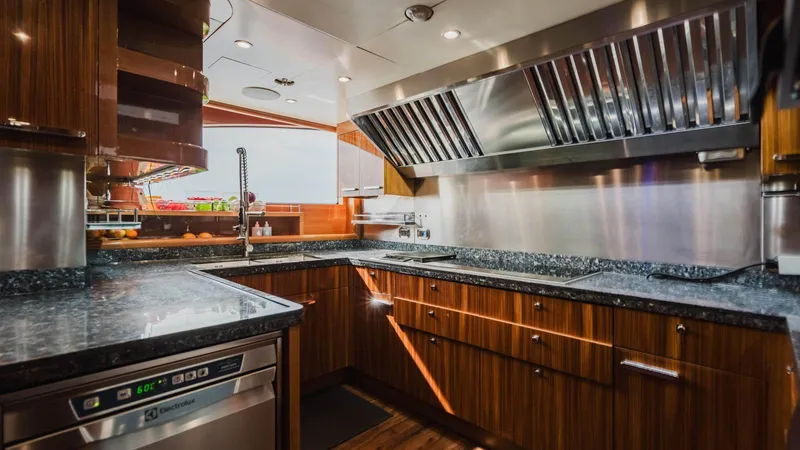 Groover Yacht Photos Pics Luxurious kitchen interior of 2009 Benetti 145 yacht with modern appliances and wood cabinetry.