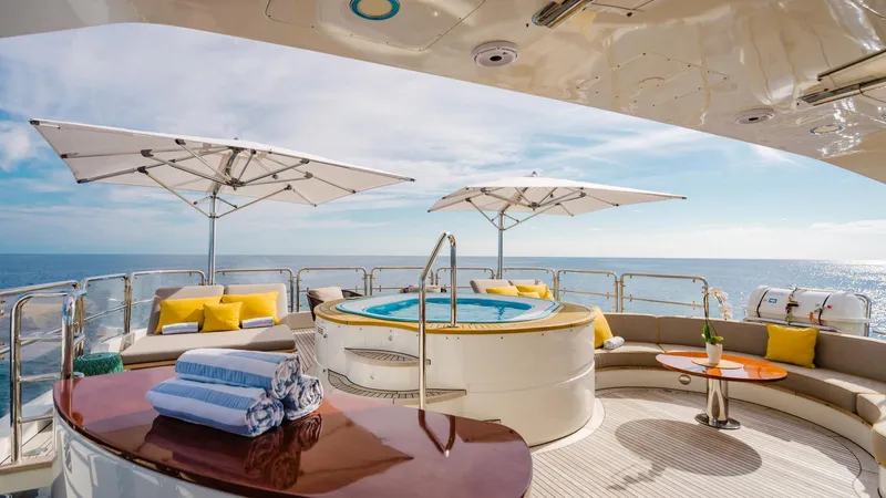 Groover Yacht Photos Pics Luxurious Benetti 145 yacht deck with jacuzzi, umbrellas, and ocean view, 2009 model.