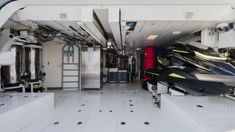 Groover Yacht Photos Pics Interior of 2009 Benetti 145 yacht with equipment and jet ski storage.