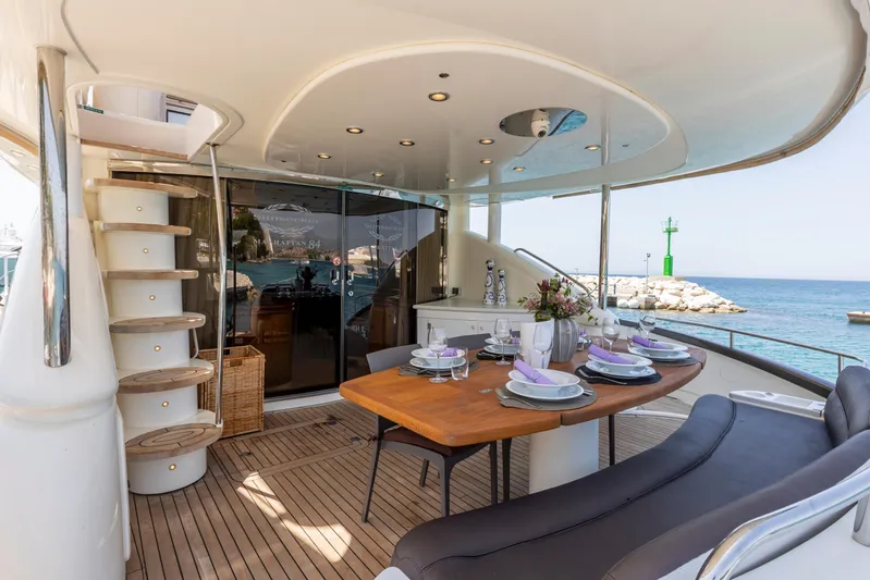 Skywater Yacht Photos Pics Luxurious Sunseeker Manhattan 84 yacht deck with dining area, ocean view, and elegant table setting.