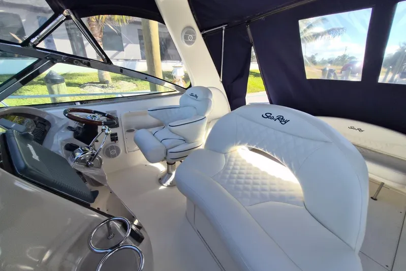  Yacht Photos Pics Luxurious interior of 2004 Sea Ray 380 Sundancer with plush white seating and helm.