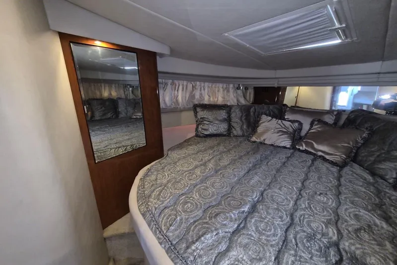  Yacht Photos Pics Luxurious cabin interior of 2004 Sea Ray 380 Sundancer with plush bedding and mirror.