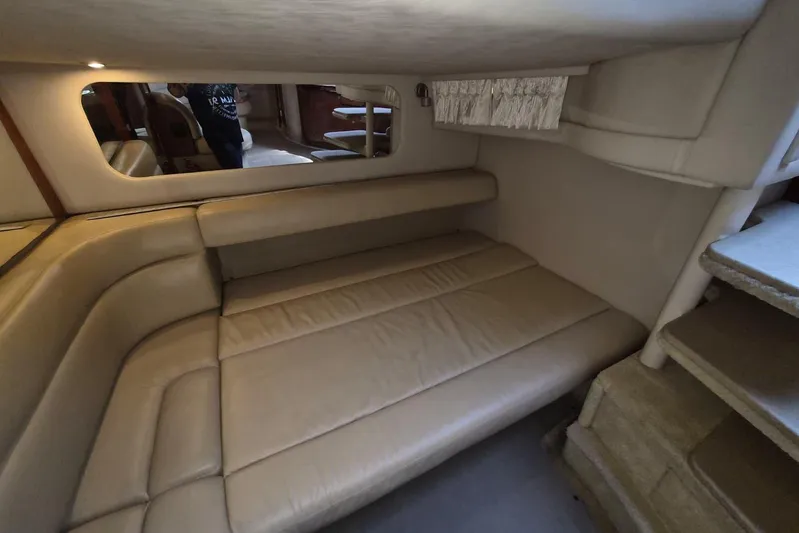  Yacht Photos Pics Interior cabin of 2004 Sea Ray 380 Sundancer with beige seating and mirror.
