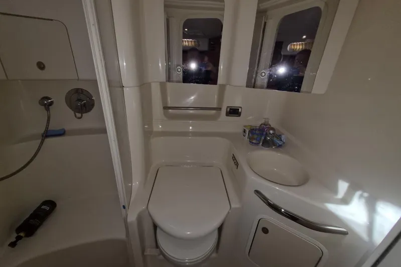  Yacht Photos Pics 2004 Sea Ray 380 Sundancer bathroom with toilet, sink, and shower area.