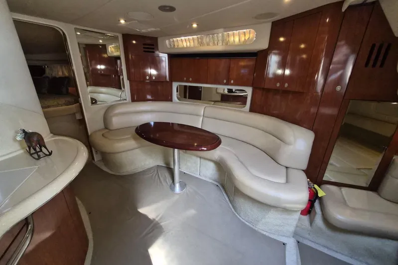  Yacht Photos Pics Luxurious 2004 Sea Ray 380 Sundancer interior with elegant seating and wooden cabinetry.