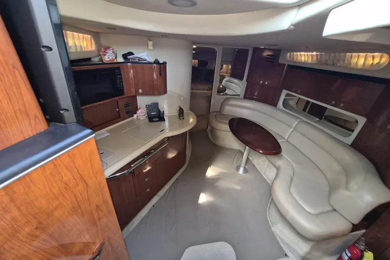  Yacht Photos Pics Luxurious interior of 2004 Sea Ray 380 Sundancer yacht with leather seating and kitchenette.