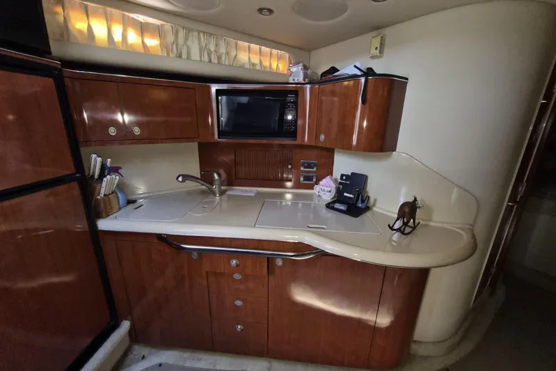  Yacht Photos Pics 2004 Sea Ray 380 Sundancer yacht kitchen with wood cabinets and modern appliances.
