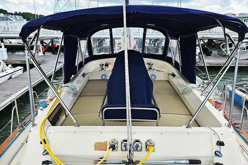  Yacht Photos Pics 2006 Island Packet 445 sailboat cockpit with blue canopy, docked at marina.
