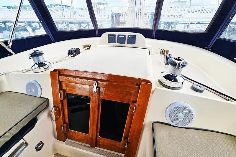  Yacht Photos Pics Cockpit of 2006 Island Packet 445 sailboat with wooden hatch and navigation equipment.