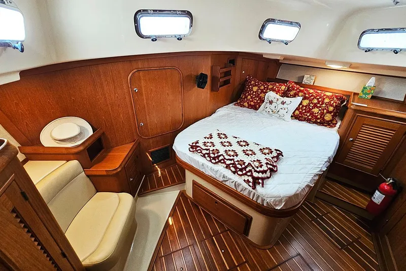  Yacht Photos Pics Luxurious 2006 Island Packet 445 yacht cabin with cozy bed and elegant wood finish.