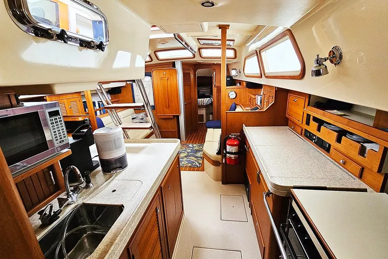  Yacht Photos Pics Interior of 2006 Island Packet 445 yacht with modern kitchen and cozy seating area.