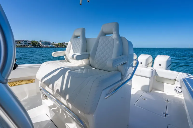  Yacht Photos Pics 2019 SeaVee 340Z boat with luxurious white seating, cruising on clear blue waters.